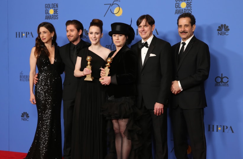 75th Golden Globe Awards – Photo Room – Beverly Hills, California, U.S., 07/01/2018 – Creator Amy Sherman-Palladino (4th L) and producer Daniel Palladino pose backstage with their awards for Best Televsision Series - Musical or Comedy for "The Marvelous Mrs. Maisel" along with cast members Marin Hin (photo credit: REUTERS/LUCY NICHOLSON)
