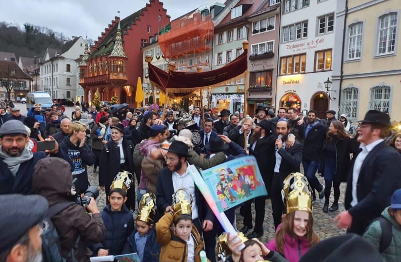 Jews in the German city of Freiburg dance down a street that was once Adolf Hiter Street with a new Torah. (photo credit: CHABAD OF FREIBURG)
