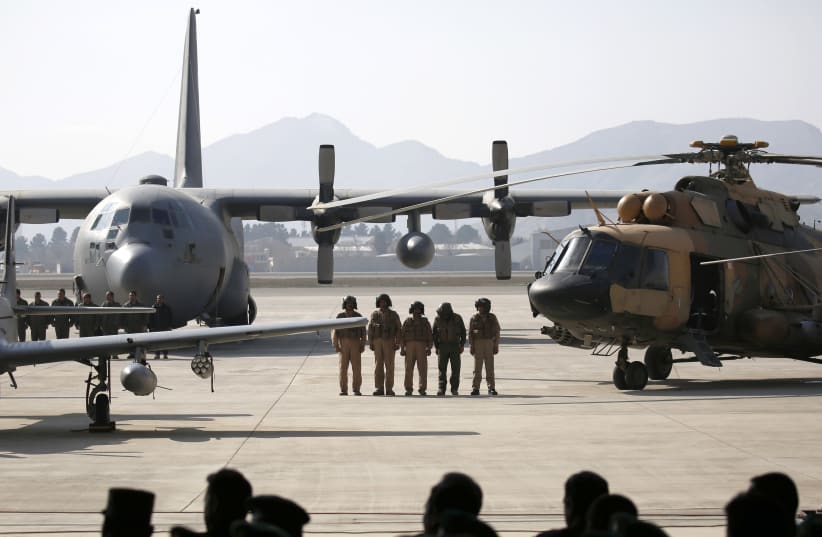Afghan pilots stand among aircrafts during the Afghanistan Air Force readiness performance program at a military airfield in Kabul (photo credit: REUTERS)