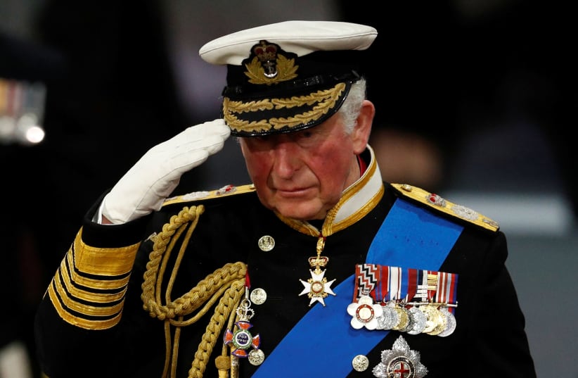 Britain's Prince Charles salutes during the official commissioning ceremony of HMS Prince of Wales, in Portsmouth, Britain December 10, 2019. (photo credit: PETER NICHOLLS/REUTERS)