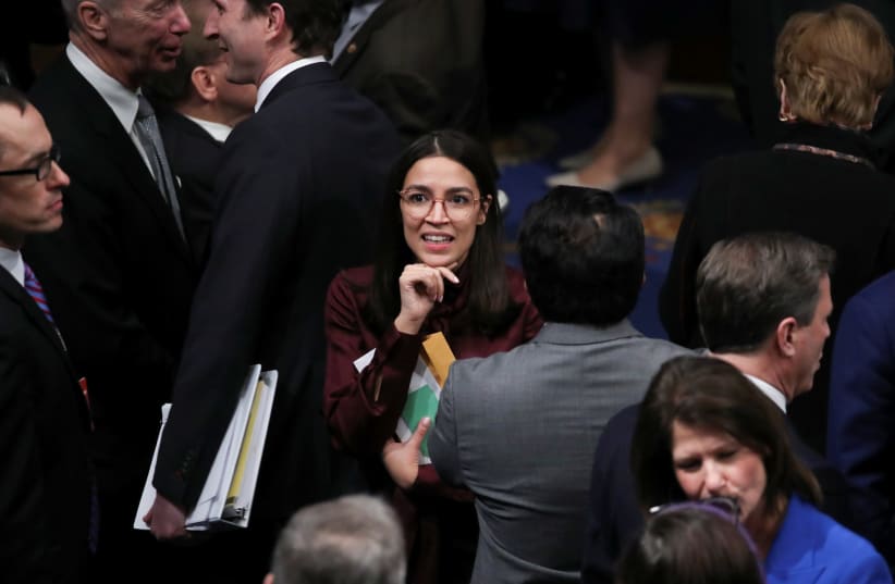 U.S. House of Representatives members talk after voting on Trump impeachment on Capitol Hill in Washington (photo credit: REUTERS)