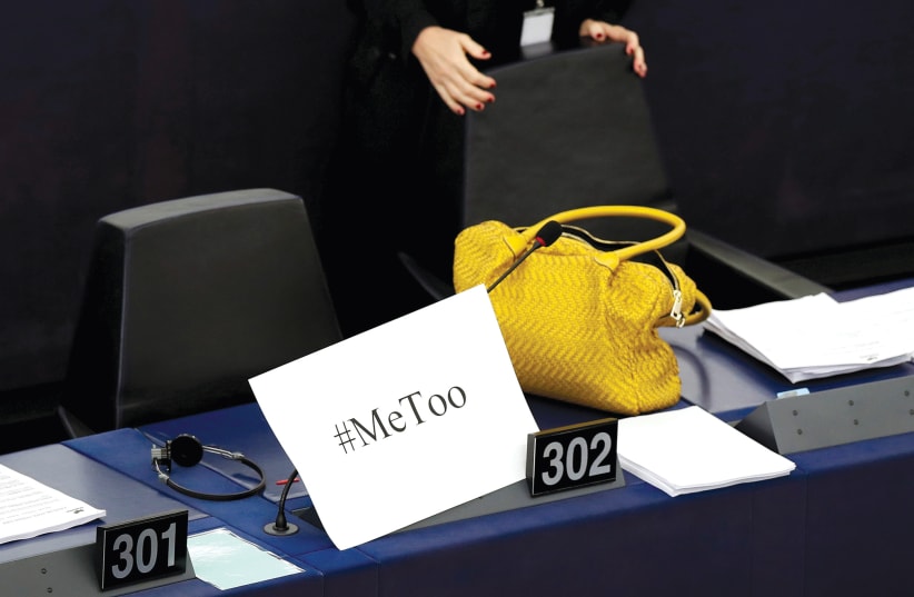 A placard with the hashtag '#MeToo' is seen on the desk of a European Parliament member during a debate in October 2017.  (photo credit: CHRISTIAN HARTMANN/REUTERS)