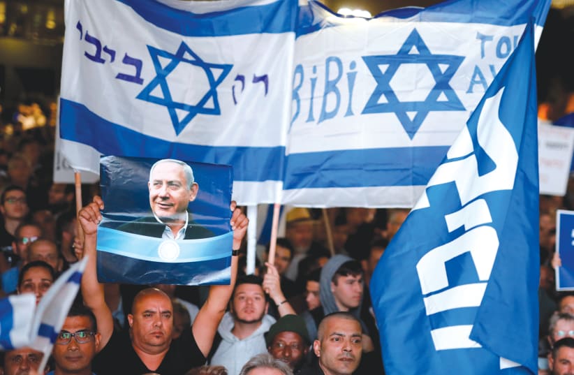 SUPPORTERS OF Prime Minister Benjamin Netanyahu rally for him in Tel Aviv last month.  (photo credit: AMIR COHEN/REUTERS)