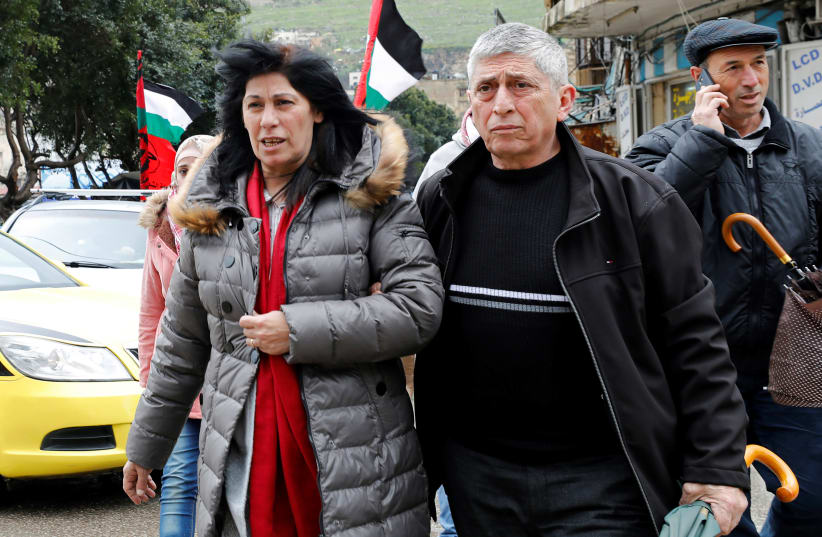 Khalida Jarrar, a senior Popular Front for the Liberation of Palestine's (PFLP) political figure, walks with people after she was released from an Israeli jail, in Nablus, in the Israeli-occupied West Bank February 28, 2019 (photo credit: ABED OMAR QUSINI/REUTERS)