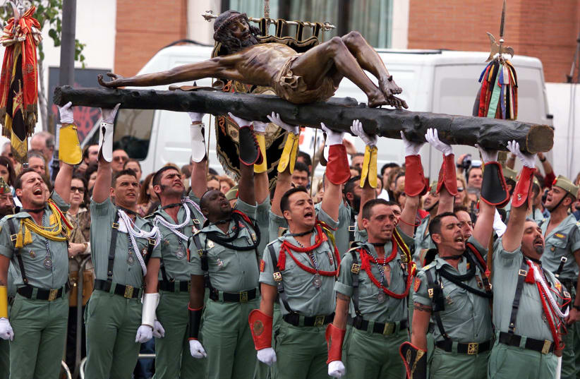 LEGIONAIRES CARRY AN IMAGE OF CHRIST DURING AN EASTER PROCESSION IN MALAGA (photo credit: REUTERS)