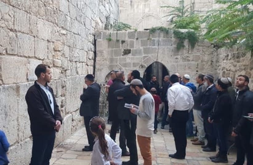 Religious Services Minister Yitzhak Vaknin prays at the Little Western Wall site in the Muslim Quarter of the Old City of Jerusalem on Monday (photo credit: COURTESY RELIGIOUS SERVICES MINISTRY)