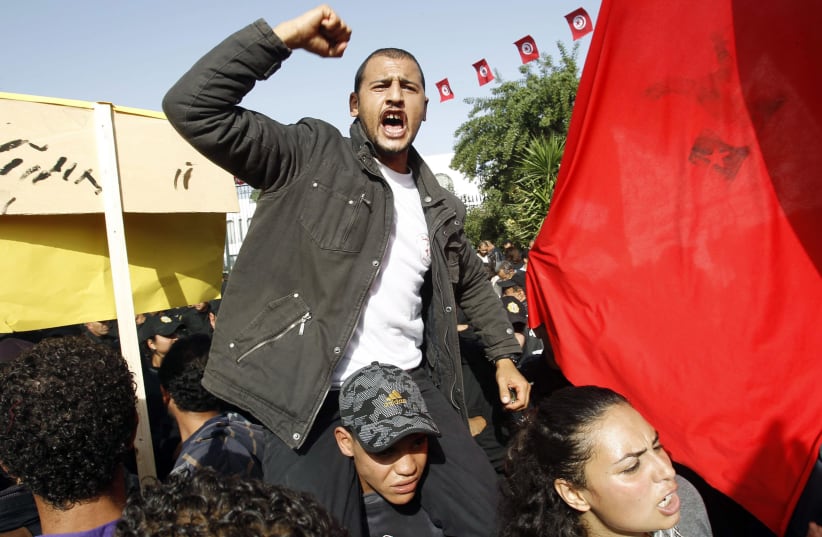 A protester shouts "We want justice!" during a demonstration outside the parliamentary building in Tunis, November 22, 2011 (photo credit: REUTERS/ZOUBEIR SOUISSI)