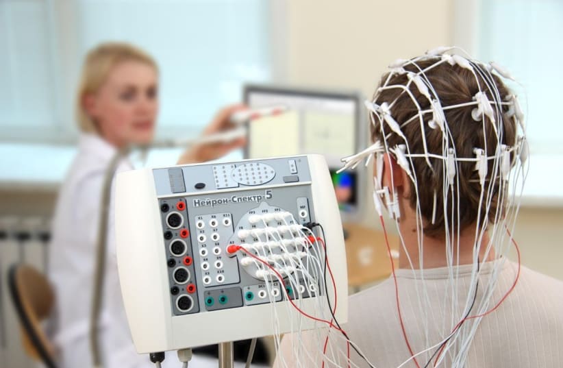 Illustrative image of an EEG test to measure electrical activity of the brain being performed. (photo credit: Wikimedia Commons)