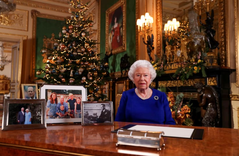 Britain's Queen Elizabeth poses, after recording her annual Christmas Day message in Windsor Castle, in Berkshire, Britain, in this undated pool picture released on December 24, 2019. (photo credit: STEVE PARSONS/POOL VIA REUTERS)