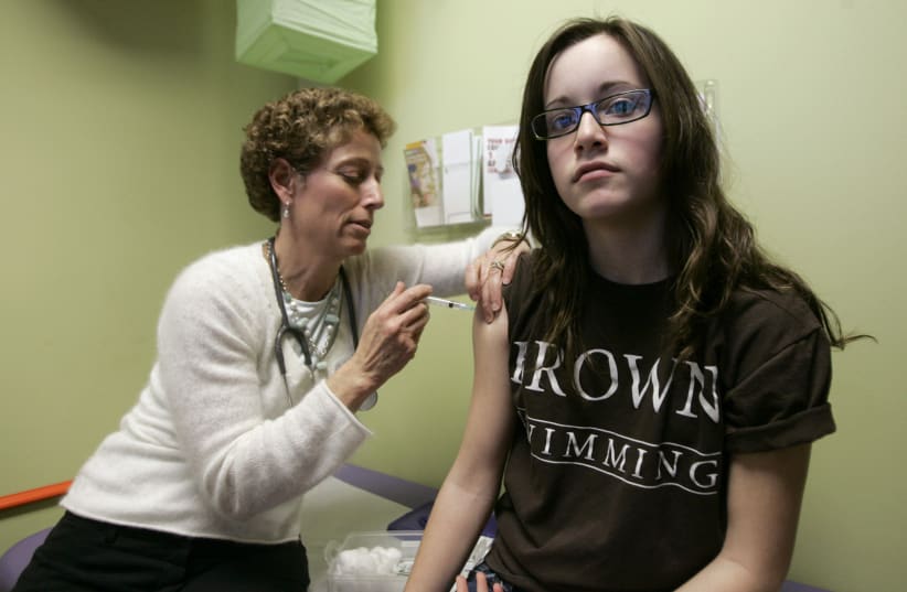 Brajtbord administers a shot of gardasil, a Human Papillomavirus vaccine, to a 14-year old patient in Dallas. (photo credit: REUTERS/JESSICA RINALDI)
