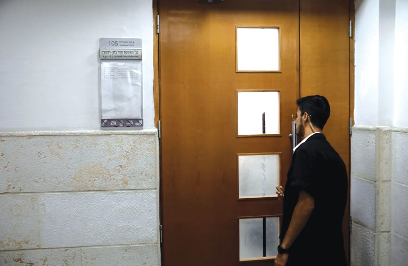 A SECURITY GUARD at a courthouse in Jerusalem. (photo credit: REUTERS)
