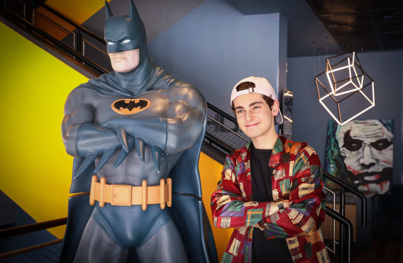 Actor David Mazouz, who plays the role of Bruce Wayne in the television show 'Gotham', standing next to a full-size statue of Batman shown at the Link Hotel in Tel Aviv.   (photo credit: MARC ISRAEL SELLEM)