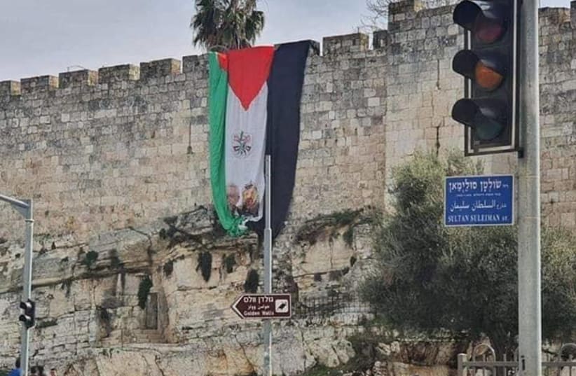 PLO flag hoisted over Jerusalem's Old City walls near the Damascus Gate, Jan. 1, 2020 (photo credit: MAOR TZEMACH/LACH JERUSALEM)