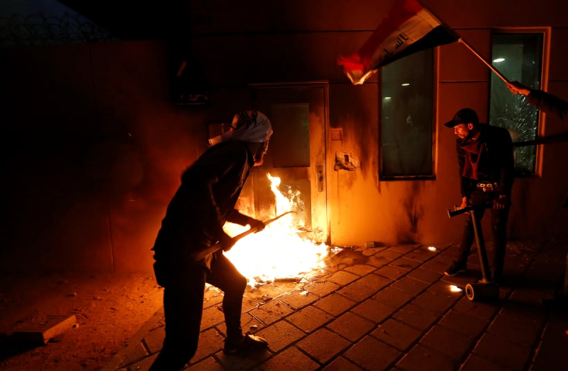 Protesters and militia fighters set fire to a reception room of the US Embassy in Baghdad, Dec. 31, 2019 (photo credit: WISSM AL-OKILI/REUTERS)