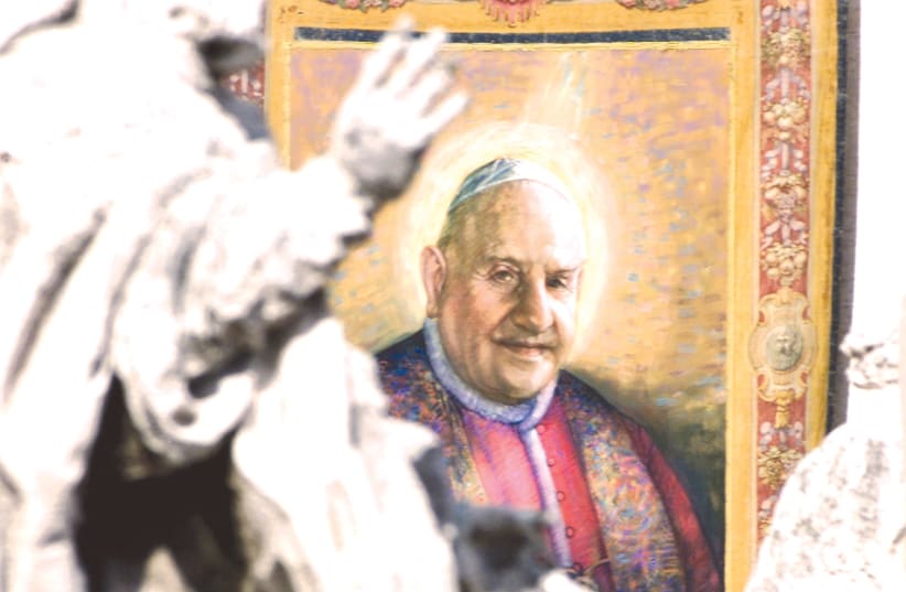 A TAPESTRY with the image of Pope John XXIII (1881-1963) hangs on the facade of St. Peter’s facade during a beatification ceremony celebrated by Pope John Paul II (photo credit: REUTERS)