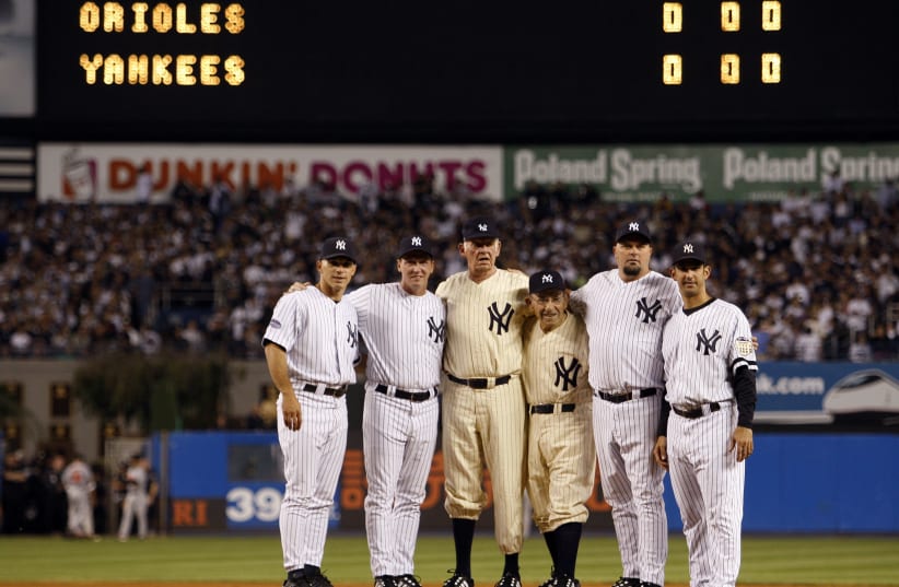 Former New York Yankees Girardi, Cone, Larsen, Berra and Wells join Posada on the mound before the final regular season MLB American League baseball game at Yankee Stadium in New York (photo credit: REUTERS)