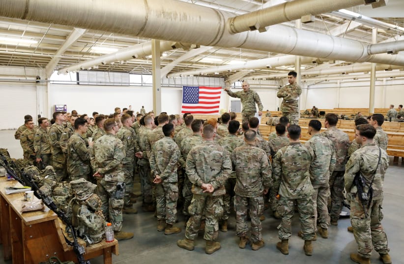 U.S. Army paratroopers from the 2nd Battalion, 504th Parachute Infantry Regiment, 1st Brigade Combat Team, 82nd Airborne Division, prepare for departure for the Middle East from Fort Bragg, North Carolina, U.S. January 4, 2020. (photo credit: JONATHAN DRAKE / REUTERS)