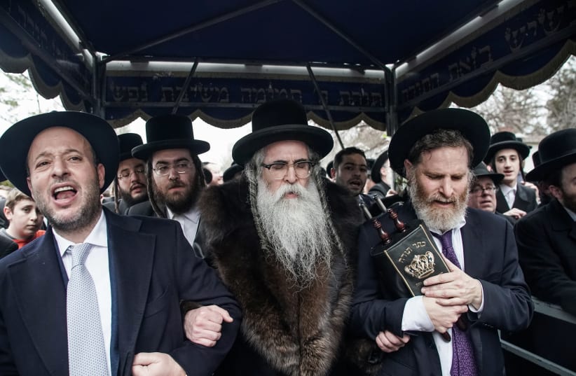 Rabbi Chaim Rottenberg celebrates with people the arrival of a new Torah at his residence in Monsey (photo credit: JEENAH MOON/REUTERS)
