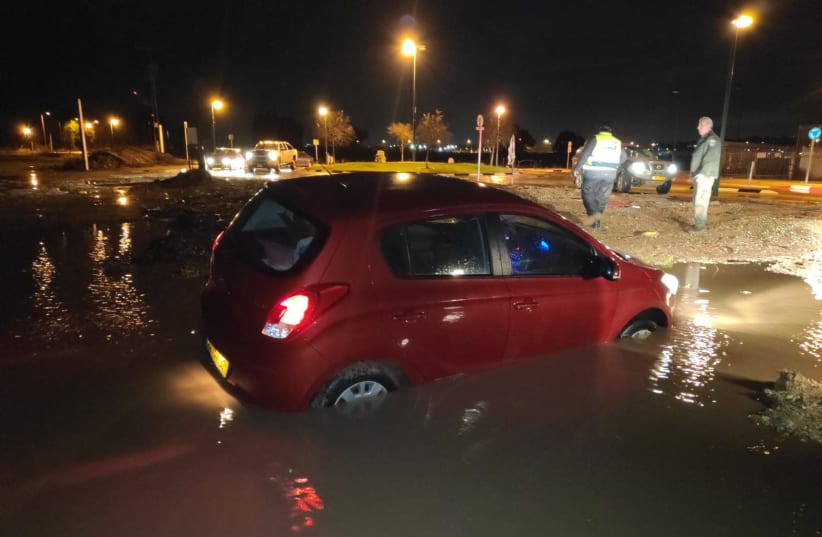 A vehicle submerged in water in northern Israel as a result of heavy rains (photo credit: OHAD AMITON/TPS)