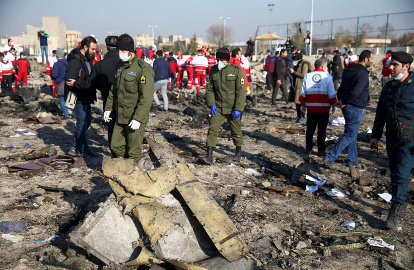 Security officers and Red Crescent workers are seen at the site where the Ukraine International Airlines plane crashed after take-off from Iran's Imam Khomeini airport, on the outskirts of Tehran, Iran January 8, 2020. (photo credit: NAZANIN TABATABAEE/WANA (WEST ASIA NEWS AGENCY) VIA REUTERS)