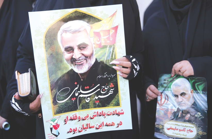 WOMEN HOLD pictures of Iranian Maj.-Gen. Qasem Soleimani during a funeral procession and burial at his hometown in Kerman (photo credit: MEHDI BOLOURIAN/FARS NEWS AGENCY/WANA (WEST ASIA N)