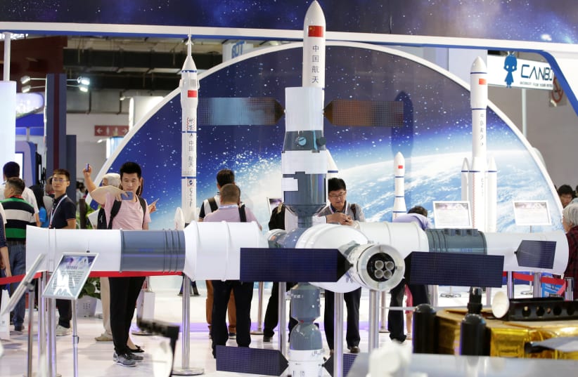 People visit the booth of China Aerospace Science and Technology Corporation at China Beijing International High-tech Expo in Beijing, China June 8, 2017 (photo credit: REUTERS/JASON LEE)