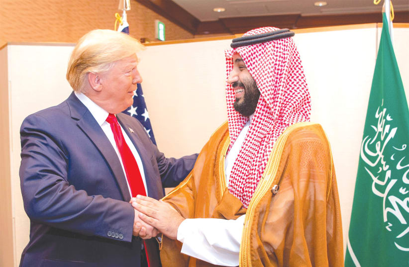 SAUDI ARABIA’S Crown Prince Mohammed bin Salman shakes hands with US President Donald Trump at the G20 leaders summit in Osaka, Japan, in June. (photo credit: BANDAR ALGALOUD/COURTESY OF SAUDI ROYAL COURT/REUTERS)