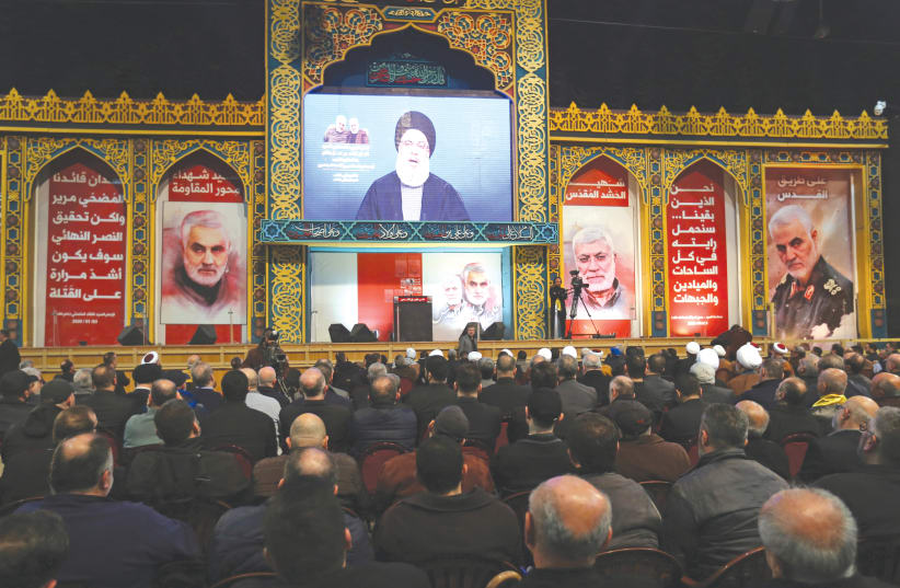 HEZBOLLAH LEADER Sayyed Hassan Nasrallah addresses his supporters via a screen during a funeral ceremony rally last week to mourn Qasem Soleimani. (photo credit: AZIZ TAHER/REUTERS)
