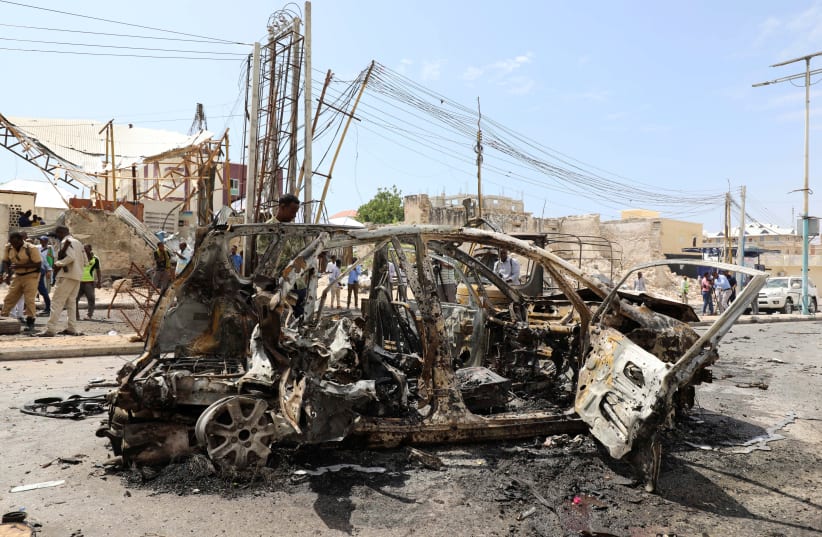 The wreckage of a car is seen at the scene of a bomb explosion at the Maka al-Mukarama street in Mogadishu, Somalia January 8, 2020 (photo credit: REUTERS/FEISAL OMAR)