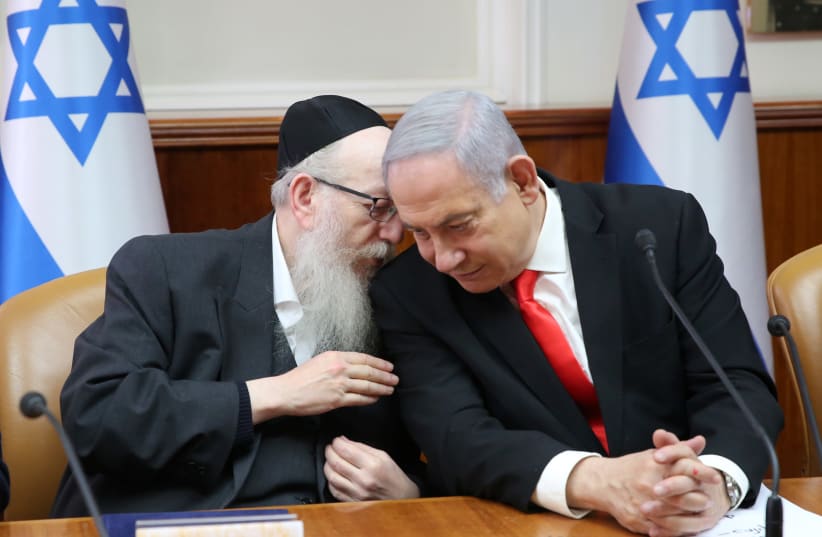 Prime Minister Benjamin Netanyahu and UTJ leader Yaakov Litzman attend the weekly cabinet meeting, January 2020. (photo credit: ALEX KOLOMOISKY / POOL)