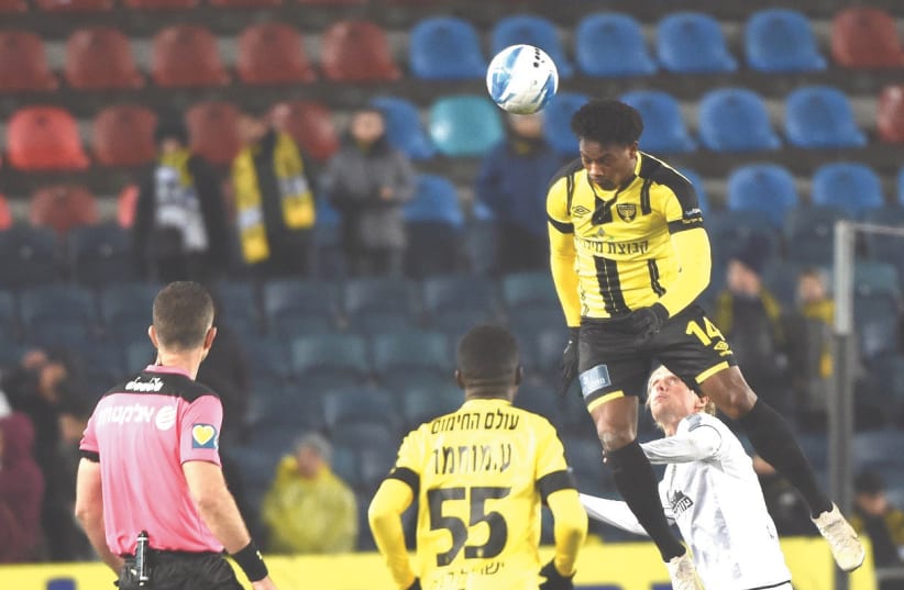 BEITAR JERUSALEM forward Levi Garcia (top) scored a pair of goals on Monday night in the yellow-and-black’s 3-1 home victory over Maccabi Netanya in Premier League action (photo credit: BERNEY ARDOV)