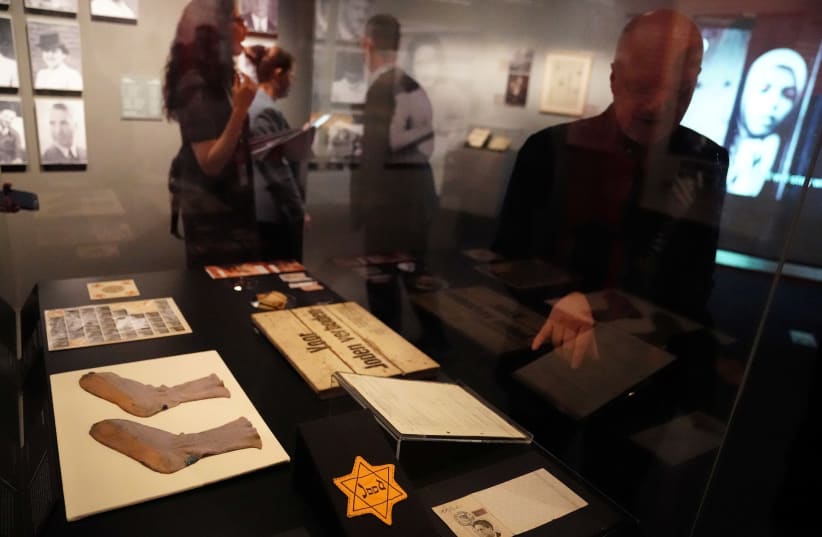 A man points at a gold star inside the Museum of Jewish Heritage in the Manhattan borough of New York (photo credit: CARLO ALLEGRI/REUTERS)