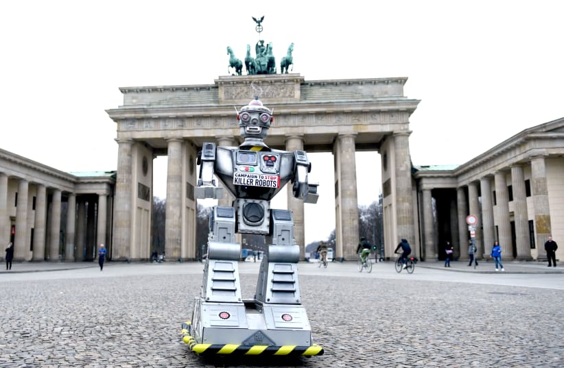 A ROBOT is pictured as activists from the Campaign to Stop Killer Robots stage a protest at Brandenburg Gate in Berlin last year. (photo credit: REUTERS)