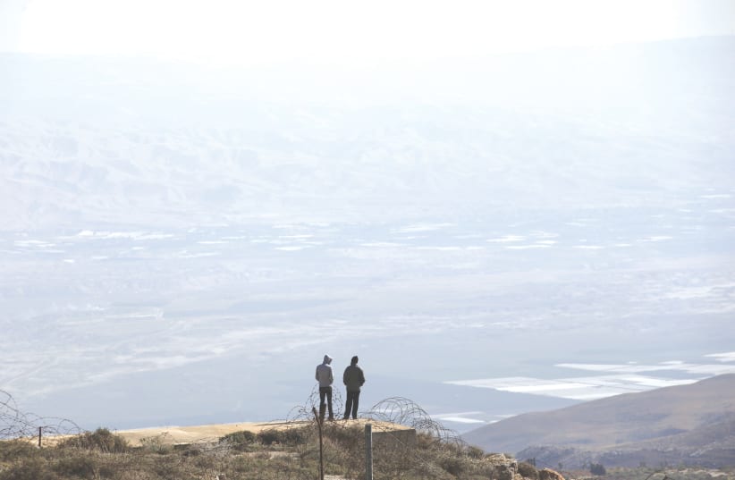 TWO ISRAELIS look over a portion of the West Bank. (photo credit: REUTERS)