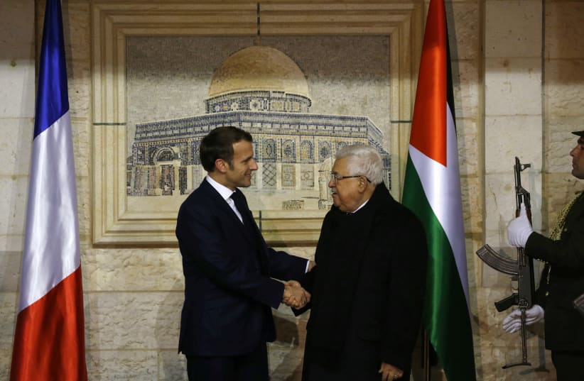 Palestinian President Mahmoud welcomes French President Emmanuel Macron at his headquarters in Ramallah in the West Bank, January 22, 2020 (photo credit: ABBAS MOMANI/POOL VIA REUTERS)