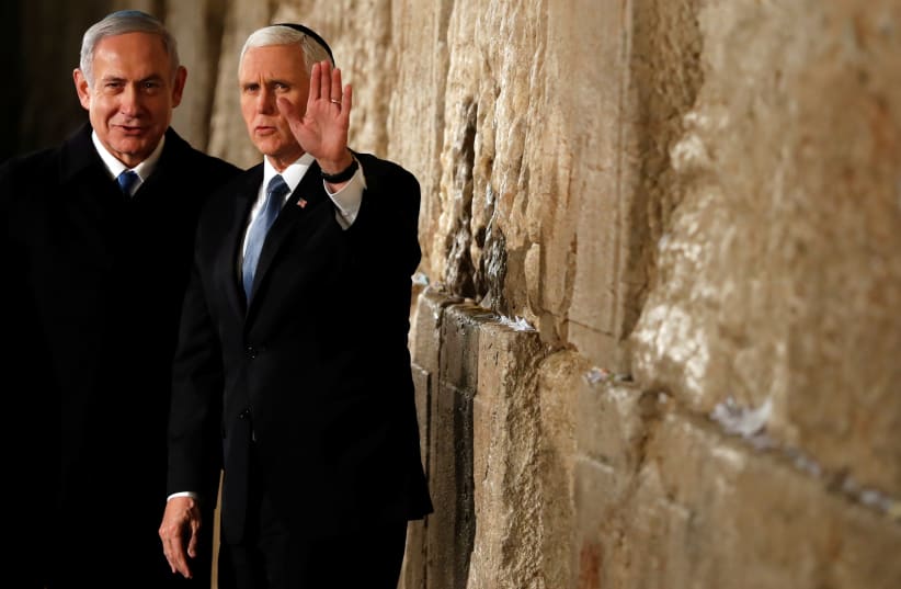 U.S Vice President Mike Pence gestures as he stands next to Israeli Prime Minister Benjamin Netanyahu during a visit to the Western Wall, Judaism's holiest prayer site, in Jerusalem's Old City January 23, 2020. (photo credit: AMMAR AWAD/REUTERS)