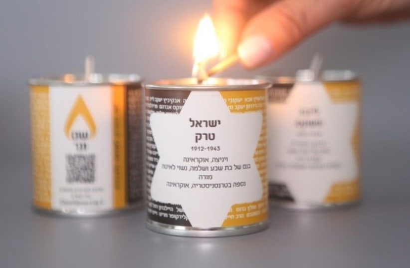 Lighting a candle in the memory of those who've perished in the Holocaust (photo credit: MARK NAYMAN)