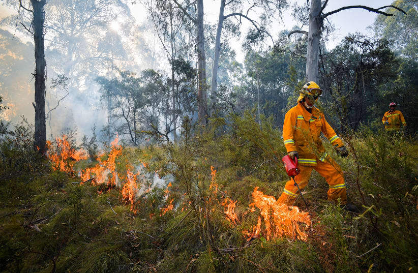 A supplied image obtained January 8, 2020 shows Country Fire Authority (CFA) strike teams performing controlled burning west of Corryong, Victoria, Australia, January 7, 2020. Picture taken January 7, 2020 (photo credit: AAP IMAGE/SUPPLIED BY STATE CONTROL CENTRE MEDIA/NEWS CORP AUSTRALIA/JASON EDWARDS/VIA REUTERS)