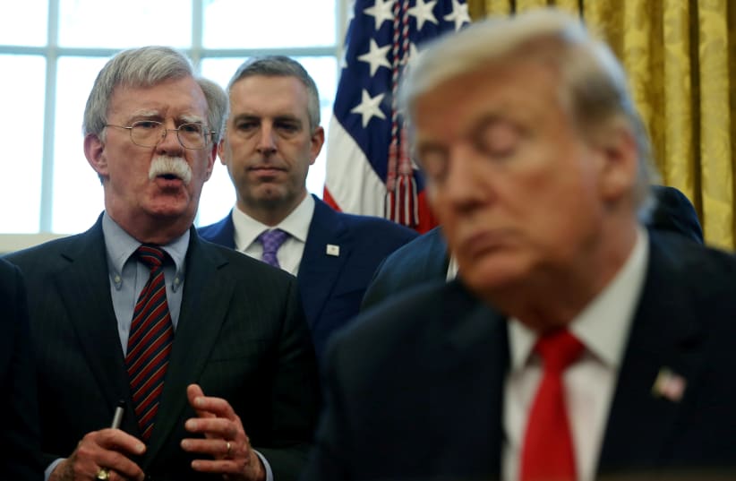 FILE PHOTO: U.S. President Donald Trump listens as his national security adviser John Bolton speaks during a presidential memorandum signing for the "Women's Global Development and Prosperity" initiative in the Oval Office at the White House in Washington, U.S., February 7, 2019 (photo credit: REUTERS/LEAH MILLIS/FILE PHOTO)