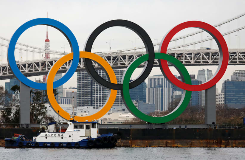 Giant Olympic Rings are installed at the waterfront area at Odaiba Marine Park in Tokyo, Japan, ahead of an official inauguration ceremony, six months before the opening of the Tokyo 2020 Summer Olympic Games, January 17, 2020 (photo credit: REUTERS/ISSEI KATO)