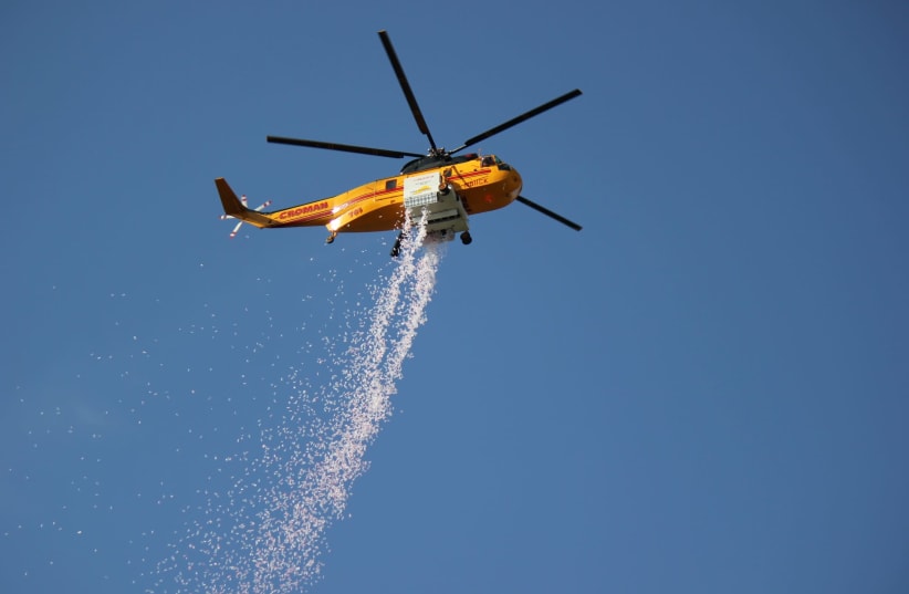 The Hydrop solution being dropped from on board a Croman aerial fire suppression helicopter. (photo credit: ELBIT SYSTEMS)