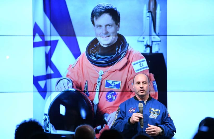 Jewish-American astronaut Garrett Reisman [R] is shown here speaking in front of the late Israeli astronaut Ilan Ramon    (photo credit: IDAN GROSS)
