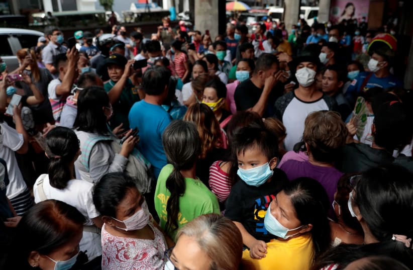A queue outside a medical supply store that sells face masks, a day after the first novel coronavirus case, in Manila, Philippines (photo credit: REUTERS/ELOISA LOPEZ)