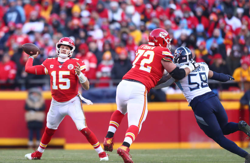 Kansas City Chiefs quarterback Patrick Mahomes (15) throws a pass as offensive tackle Eric Fisher (72) blocks Tennessee Titans linebacker Harold Landry III (58) in the AFC Championship Game at Arrowhead Stadium (photo credit: REUTERS)