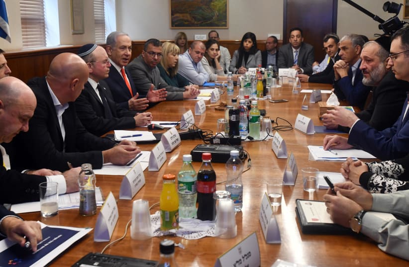 Prime Minister Benjamin Netanyahu holds an emergency meeting on the coronavirus epidemic. (photo credit: CHAIM TZACH/GPO)