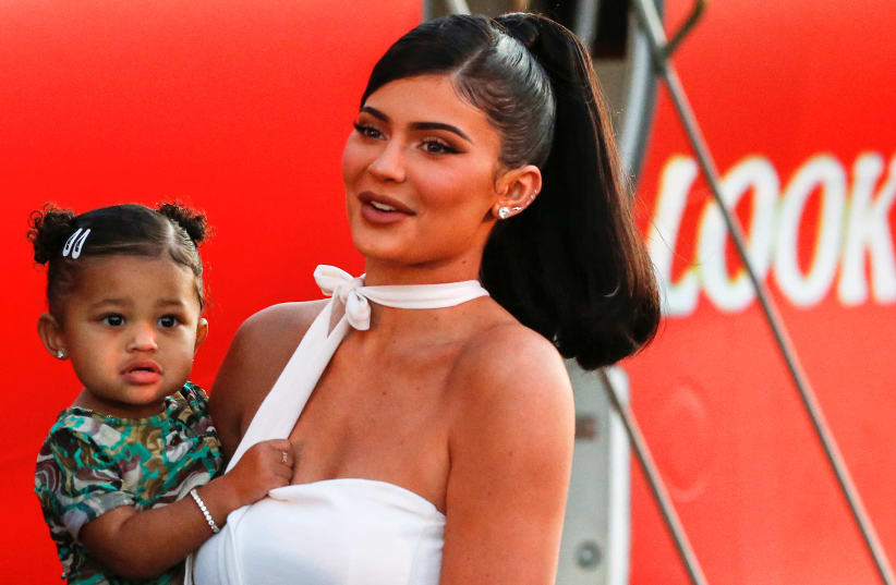 Kylie Jenner and her daughter Stormi Webster share a moment at the premiere for the documentary "Travis Scott: Look Mom I Can Fly" in Santa Monica, California (photo credit: REUTERS)