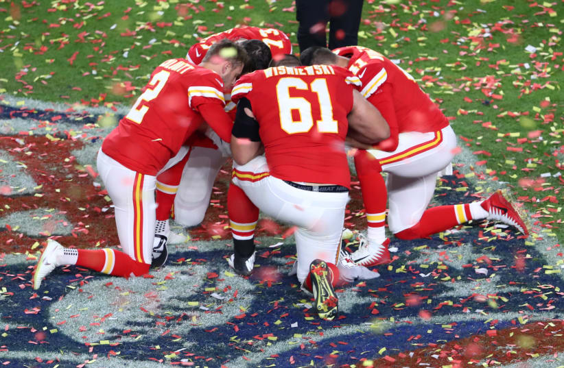 Feb 2, 2020; Miami Gardens, Florida, USA; A group of Kansas City Chiefs take a knee after defeating the San Francisco 49ers in Super Bowl LIV at Hard Rock Stadium (photo credit: KIM KLEMENT-USA TODAY SPORTS VIA REUTERS)