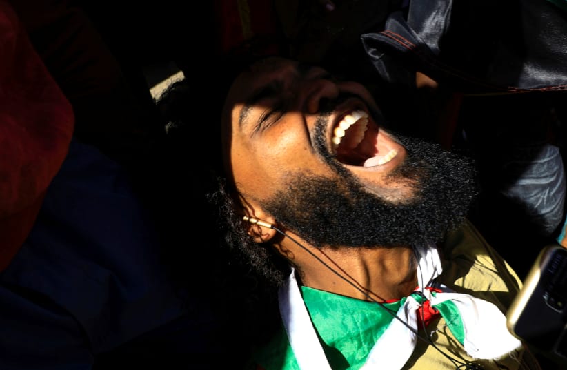 A Sudanese man reacts as he celebrates outside the court in Omdurman (photo credit: REUTERS)