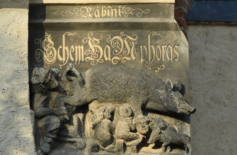 A thirteenth century anti-Semitic sculpture is displayed at St. Marien church in Wittenberg, Germany, January 24, 2020. A court is expected to rule on a motion seeking the removal of the 700-year-old sculpture known as “Judensau” or Jew pig. It is one of around 20 such relics from the Middle Ages th (photo credit: ANNEGRET HILSE / REUTERS)