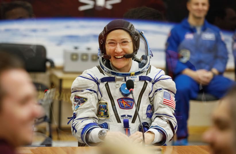 he International Space Station (ISS) crew member Christina Koch of the U.S. smiles after donning space suit check shortly before launch at the Baikonur Cosmodrome, Kazakhstan March 14, 2019 (photo credit: REUTERS/SHAMIL ZHUMATOV)